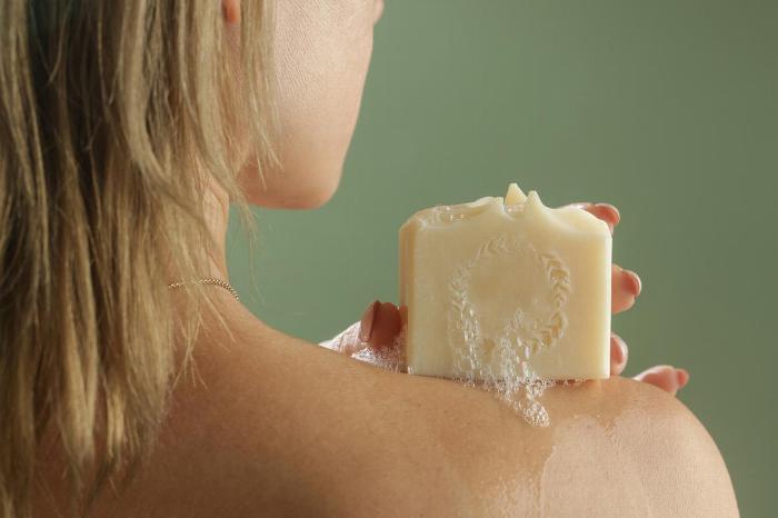woman holding a bar of natural soap