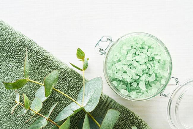 Stress buster, green aromatherapy bath salt in jar with green bath towel